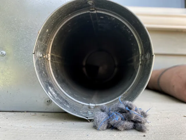 The Villages Dryer Vent Cleaning technician using specialized equipment to clear severe dryer vent blockage in The Villages